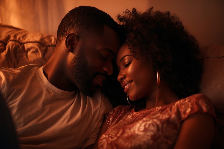 Couple enlacé tendrement sur un canapé, fronts joints